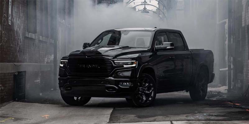 Black 2023 Ram 1500 in an ally filled with smoke.